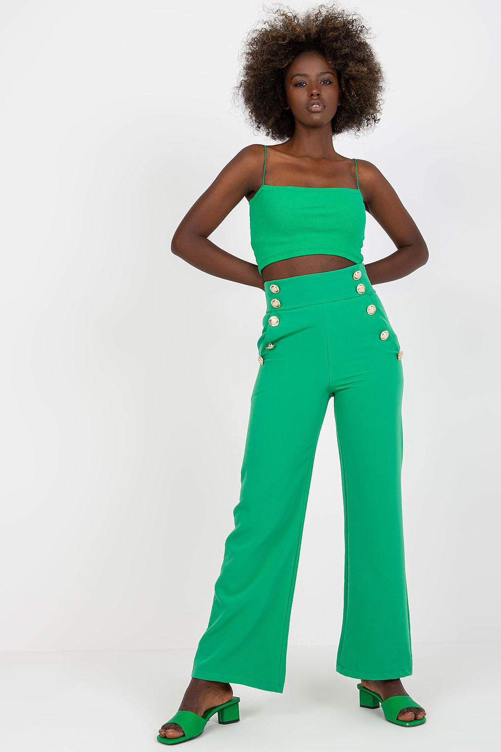 Luxury Women'S High-Waisted Trousers with Decorative Buttons in a bold green colour, styled with a matching cropped top, emanating a modern, upscale vibe.