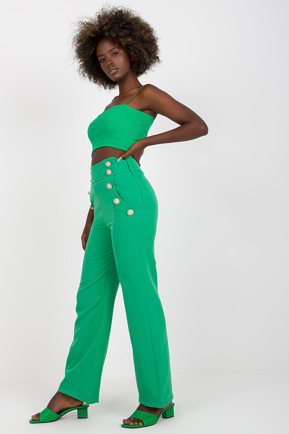 Side view of Luxury Women'S High-Waisted Trousers with Decorative Buttons in striking green, accentuating its stylish cut and luxurious appeal.