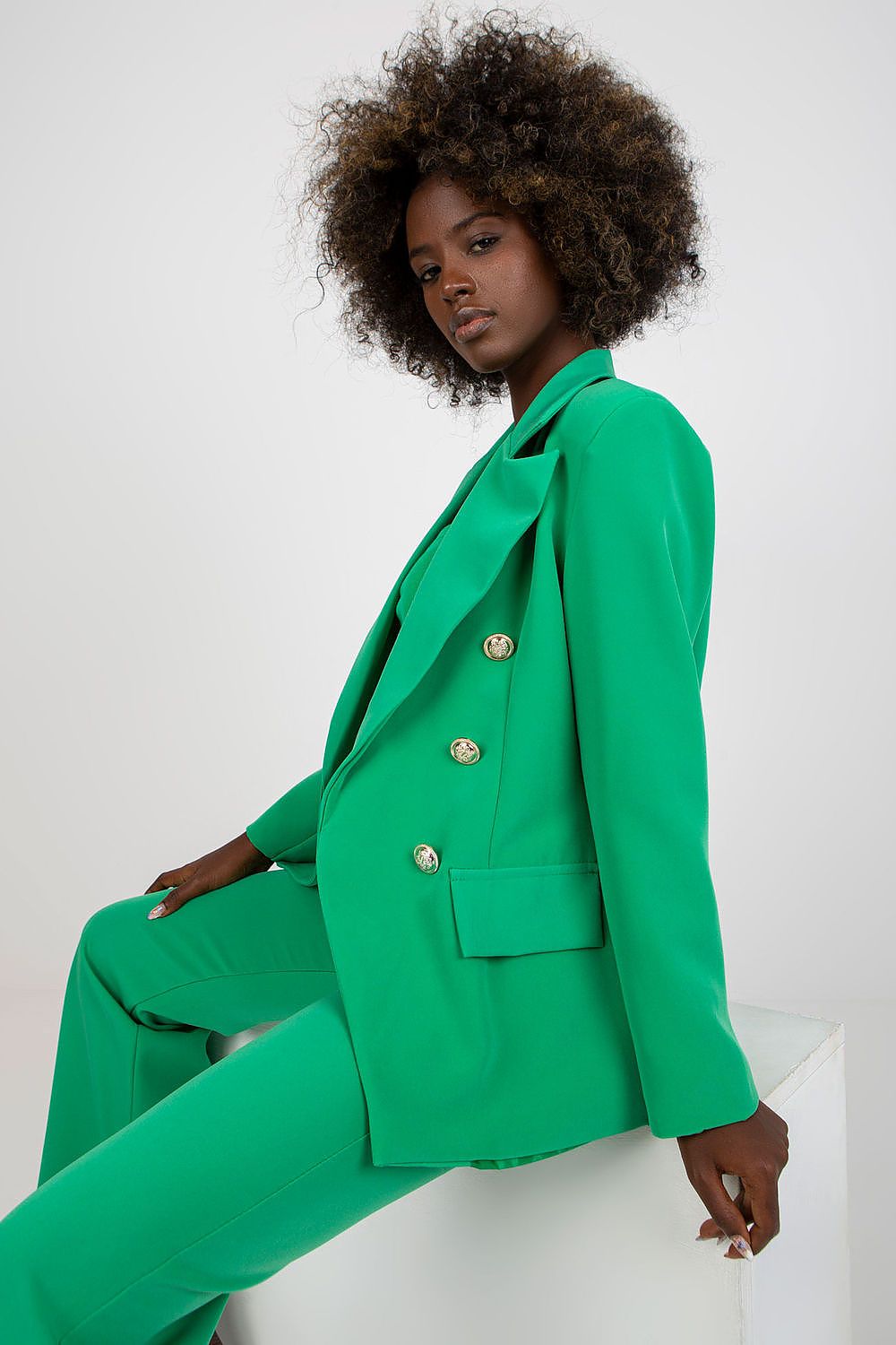 Stylish Ladies' Jacket by Italy Moda in vibrant green, styled on a model with side profile, highlighting its luxurious design and button embellishments.