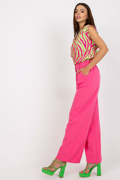 Side profile of the Luxury Women’s Italy Moda Trousers - High Rise Fabric Pants with Zip and Button Fastening, complemented by a vibrant pink ensemble, perfect for a trendy summer outing.