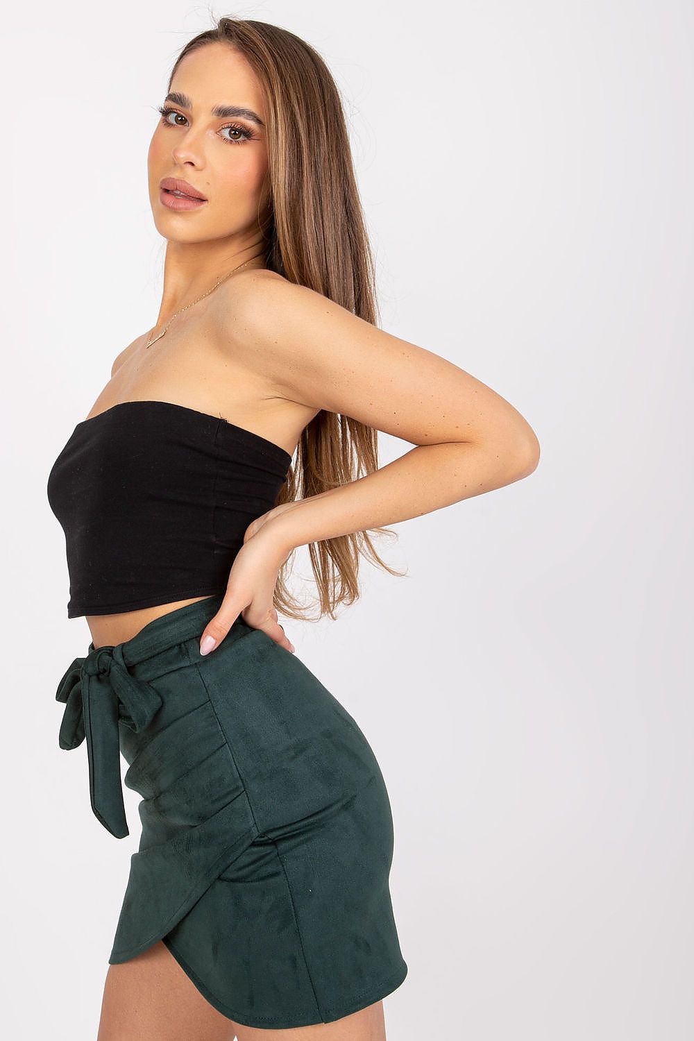 Stylish side profile of the Luxurious Asymmetrical Short Skirt with Tie Belt by Italy Moda, highlighted with a sleek black crop top.