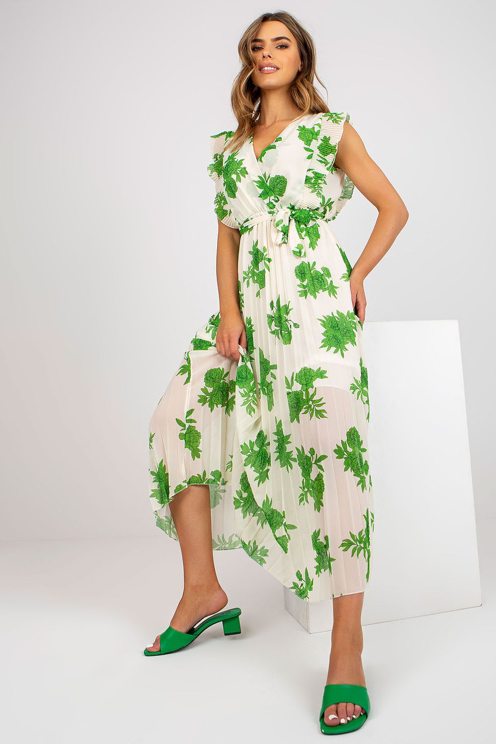 Elegant Long Summer Dress With Frilled Sleeves And Pleated Hem by Italy Moda, presenting a stylish and trendy look with a lively green floral design, perfect for warm weather occasions.