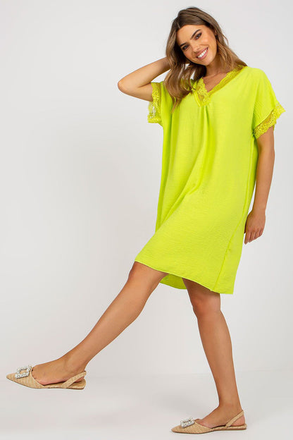 A glamorous view of the Elegant Loose-Fit Daydress by Italy Moda in neon yellow, illustrating the luxurious lace details at the sleeves and neckline, paired with sophisticated footwear.