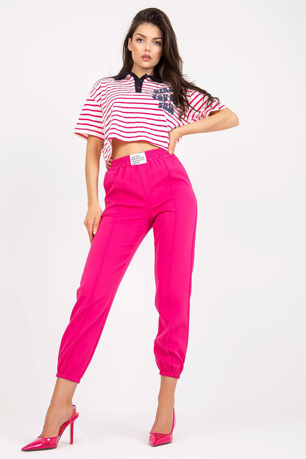 Chic women's luxury high-rise trousers with elastic waist and pockets by Italy Moda, showcased in vibrant pink with a stylish cropped striped top, perfect for a trendy outfit.