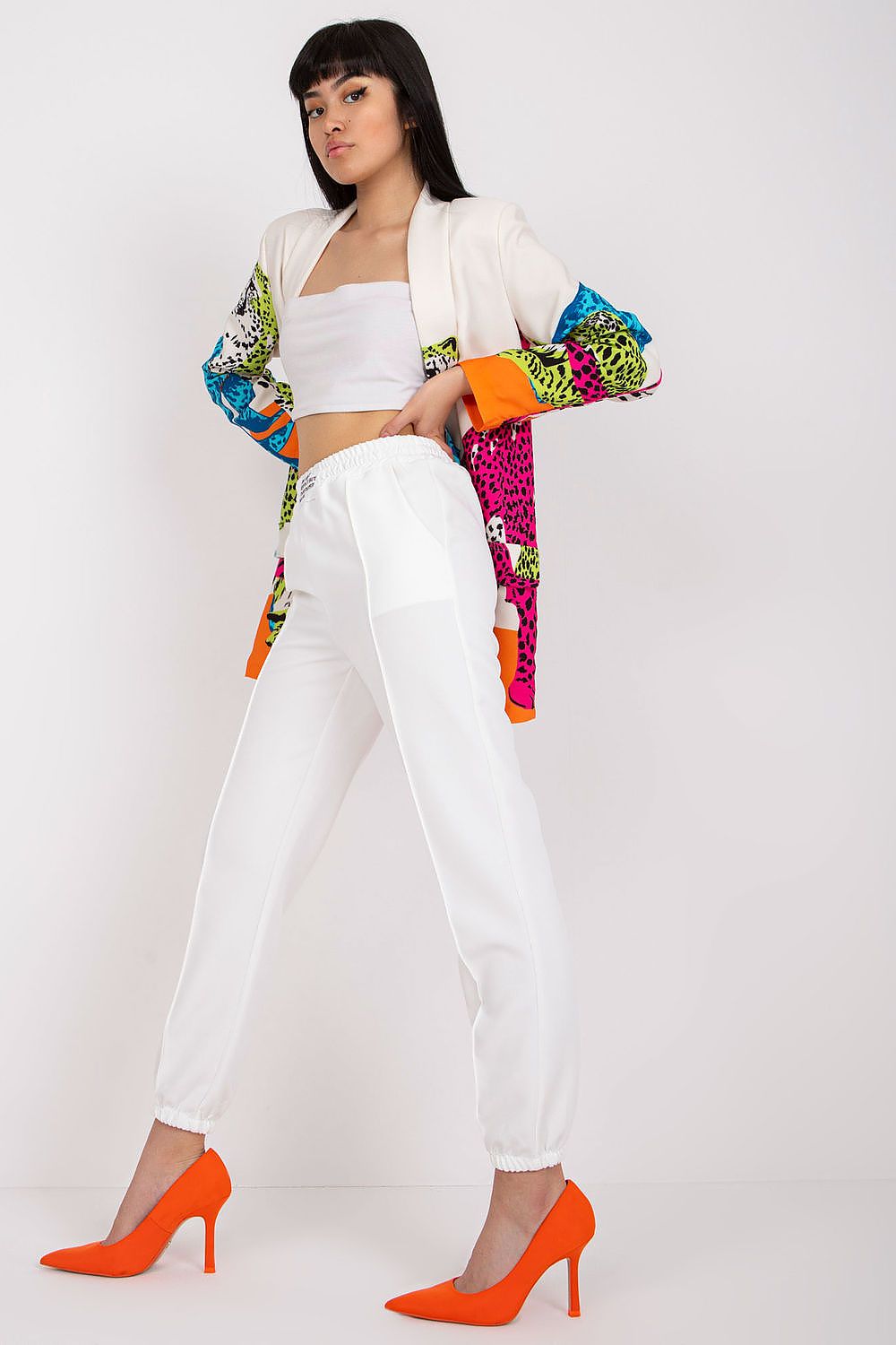 Fashion-forward woman showcasing Women’s Luxury High-Rise Trousers with Elastic Waist and Pockets by Italy Moda, complemented by a chic blazer and striking orange footwear.