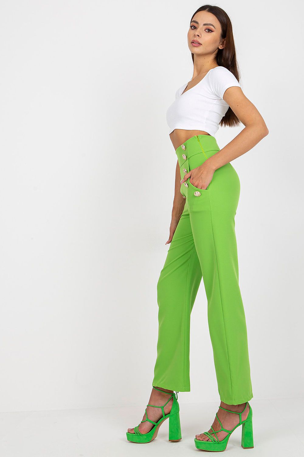 Stylish green high-waisted trousers with decorative buttons by Italy Moda, model poses confidently showing side view.
