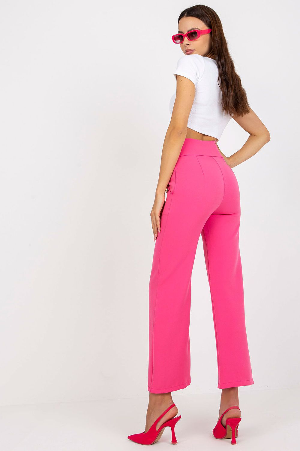 Luxury Women'S High-Waisted Trousers with Decorative Buttons by Italy Moda, showcasing a fashionable back view of the vibrant pink trousers and model in a chic white top.
