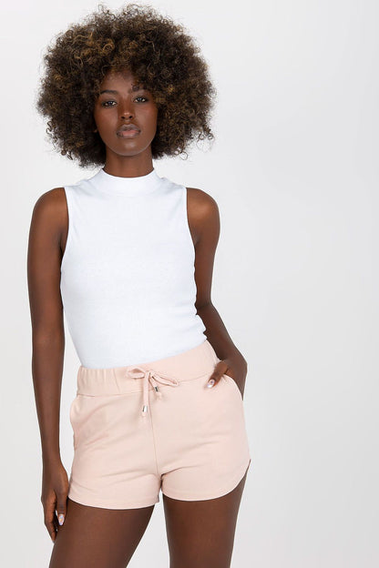 Elegant high-waisted cotton spandex sweatshorts featuring a drawstring and slip-on pockets, styled with a chic white sleeveless top.