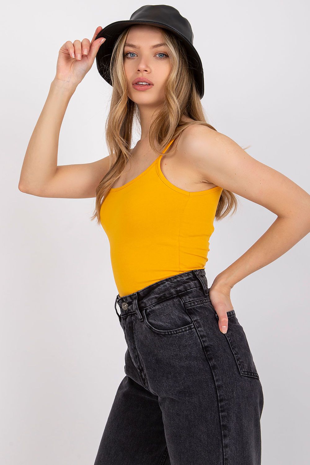 Luxurious Cotton Spandex Strapless Shirt with Round Neckline - Side profile of a model in a chic yellow strapless shirt and black high-waisted jeans, embodying luxury and versatility.