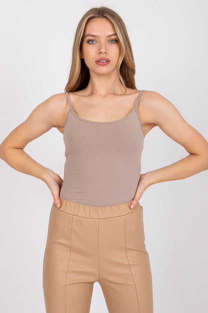 Model in a luxurious cotton spandex strapless shirt with round neckline in a chic taupe colour, styled with beige leather trousers - perfect for versatile styles.