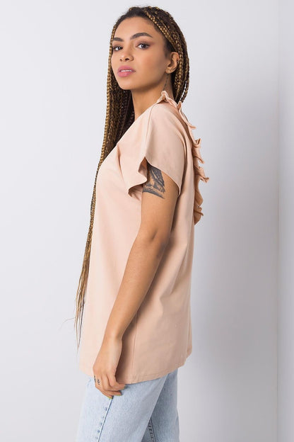 Side view of elegant short sleeve blouse with frill trimmed deep cut-out, featuring soft peach fabric, designed for a luxurious look, model wearing EU Size 0.