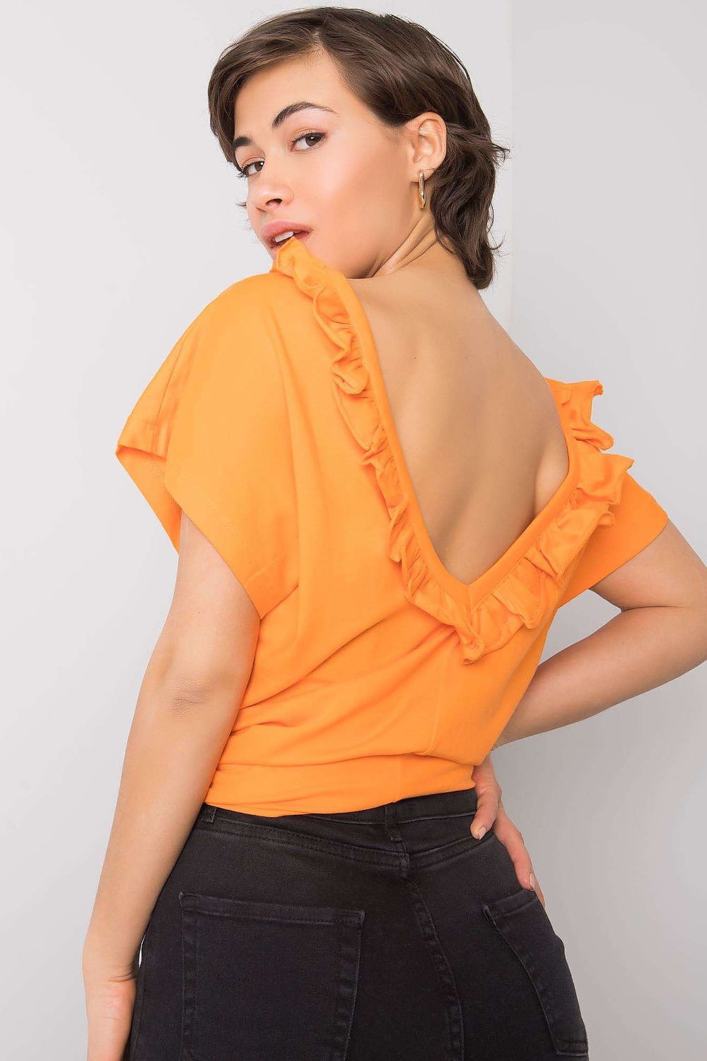 Elegant Short Sleeve Blouse With Frill Trimmed Deep Cut-Out, Cotton-Lycra Blend, EU Size 0, showcasing the unique ruffle detail at the back with a sultry deep cut-out, elegantly styled with high-waisted pants.