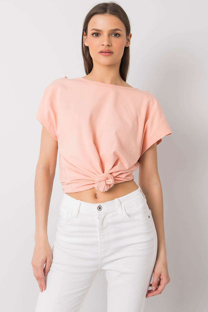 Elegant short sleeve blouse with frill trimmed deep cut-out, presented in a soft peach tone, featuring a stylish knotted front, ideal for a chic casual look.