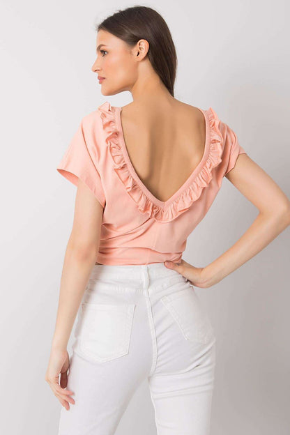 Elegant short sleeve blouse with frill trimmed deep cut-out, captured from the back in a delicate peach colour, highlighting its unique ruffled neckline design.