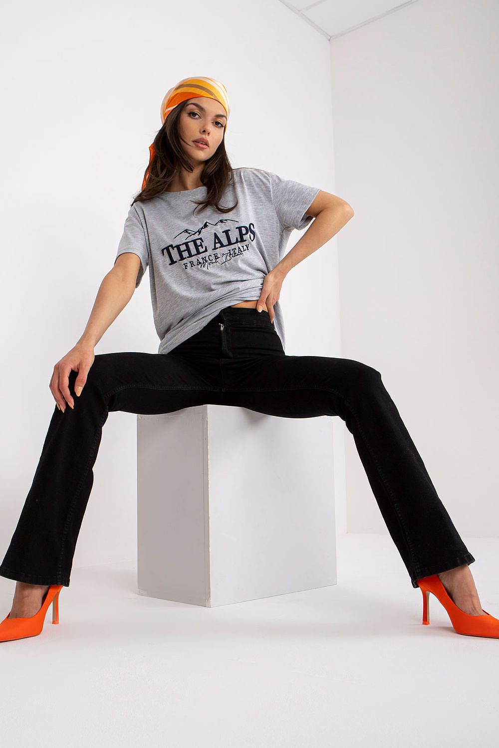 Stylish Cotton Blend T-Shirt with Embroidered Design on a model wearing black jeans and orange heels, showcasing relaxed elegance. EU Size 0, 68 cm Length, 114 cm Chest.