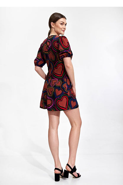 Elegant Summer Mini Dress by Figl featuring a vibrant heart pattern, loose sleeves, and a flared bottom, elegantly showcased on a model from the back.