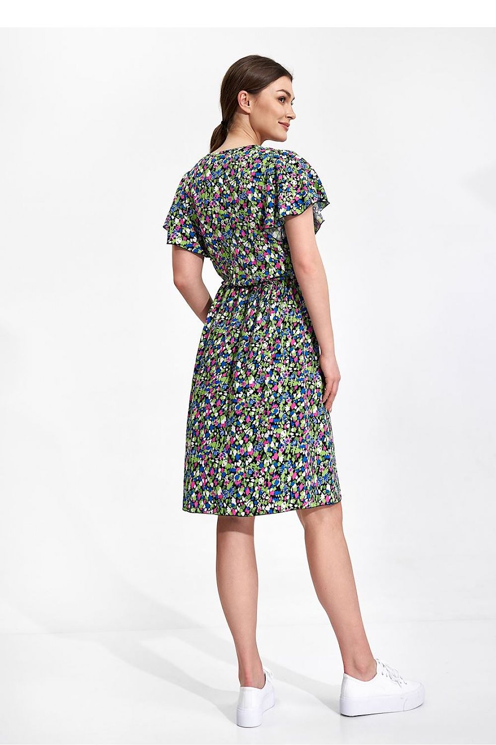 Summer Midi Dress by Figl showcasing the rear view, highlighting the ethereal sleeves and decorative slit in a beautiful floral pattern. The model exudes confidence in this elegant summer outfit.