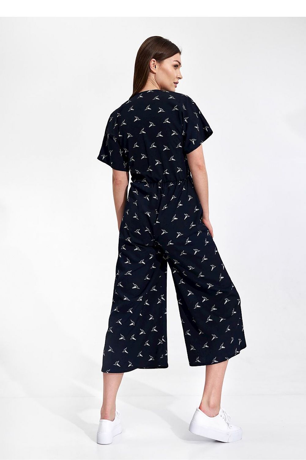 Luxury Figl 7/8 Length Kimono Sleeve Overalls with Elastic Waist and Decorative Ties displayed by a model from the back, highlighting a fashionable long leg cut in navy.