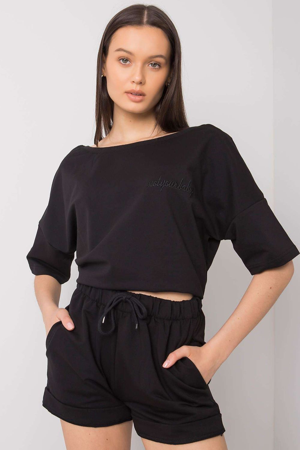 Elegant Cotton Blouse And Shorts Set With Elastic Waistband And Slip-On Pockets in classic black, model exuding luxury and comfort in this exquisite outfit.