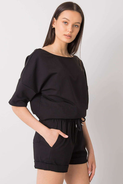 Elegant Cotton Blouse And Shorts Set With Elastic Waistband And Slip-On Pockets. Close-up view of a fashionable black outfit featuring a relaxed blouse and shorts with a drawstring waist, ideal for effortless elegance.