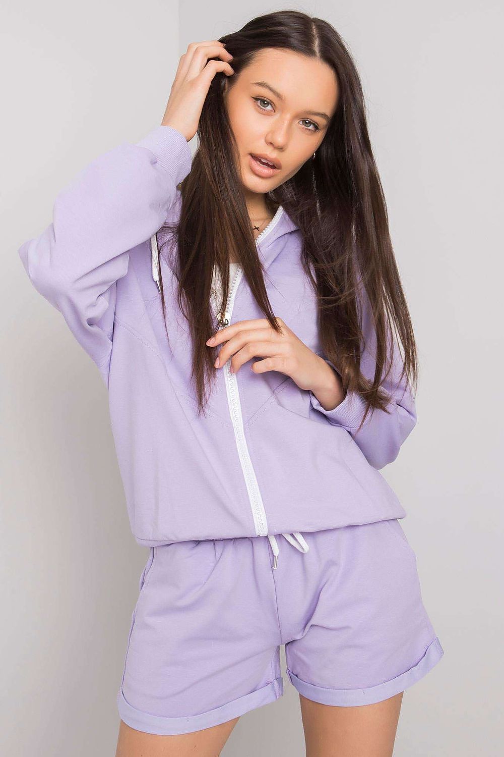 Luxury Tracksuit Set featuring a stylish hoodie sweatshirt with zipper and comfortable shorts in lavender, model showcasing stylish wears and relaxed attitude.