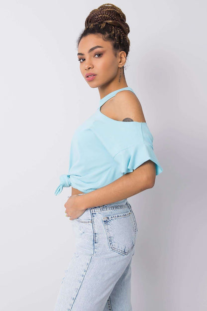 Stylish Off-Shoulder Cotton Blend Blouse with Short Sleeves displayed from the side, featuring a sophisticated cut that highlights the shoulder, paired with classic distressed blue jeans for an effortlessly trendy ensemble.