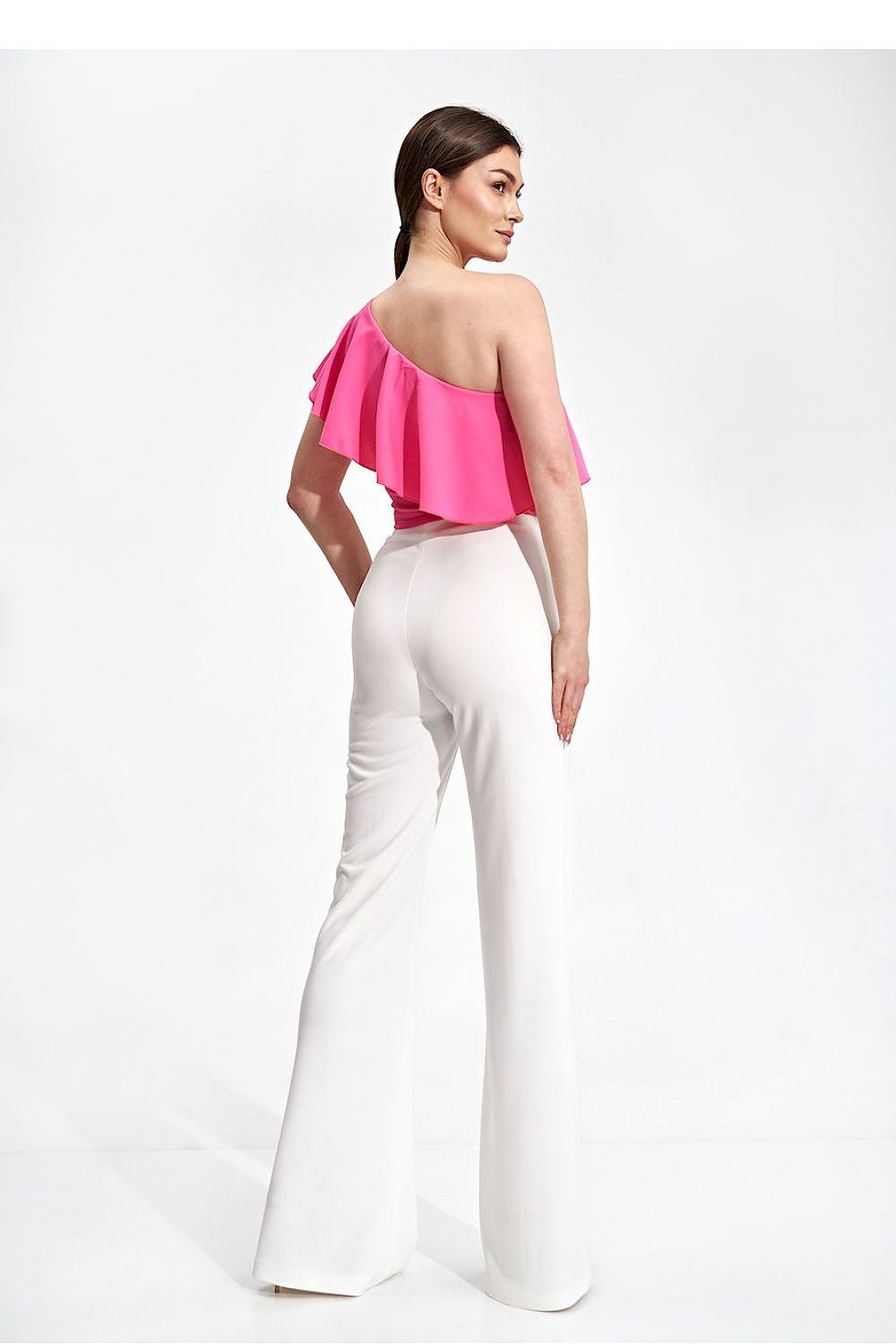 Back view of the Elegant One Shoulder Ruffle Crop Top Blouse by Figl in pink, paired with luxurious white flared trousers, ideal for elegant occasions.