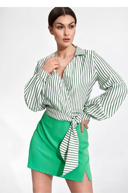 Elegant Envelope Blouse With Pleated Sleeves And Sash - Figl Fashion displayed on a model, featuring a striped green and white blouse elegantly tied at the waist, complemented by a vibrant green skirt.