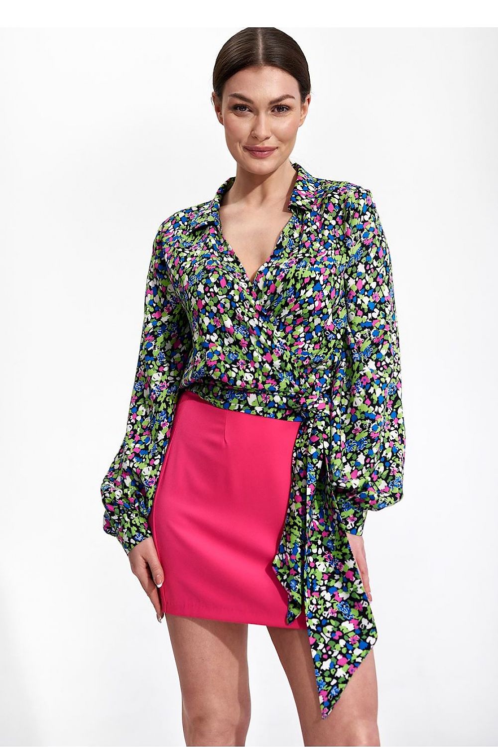 Elegant Envelope Blouse With Pleated Sleeves And Sash - Figl Fashion, featuring a model wearing a vibrant floral print blouse paired with a bright pink skirt, showcasing stylish pleated sleeves and a sash for a luxurious look.