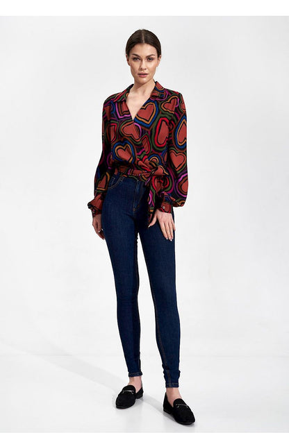 Elegant Envelope Blouse With Pleated Sleeves And Sash - Figl Fashion, showcasing a model wearing a stylish, patterned blouse with pleated sleeves, paired with dark jeans for a chic look.