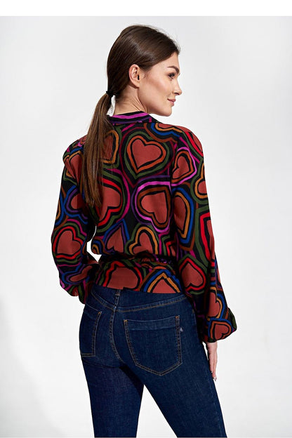 Elegant Envelope Blouse With Pleated Sleeves And Sash - Figl Fashion, featuring a model from a rear angle, highlighting the beautiful design and luxurious fabric of the blouse, elegantly styled with fitted jeans.