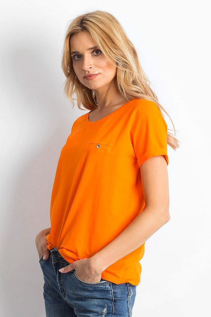 Side view of the Luxurious Ladies Cotton Spandex Short-Sleeved T-Shirt with Round Neckline, showcasing its sophisticated design and vibrant orange colour, modelled by a stylish blonde woman.
