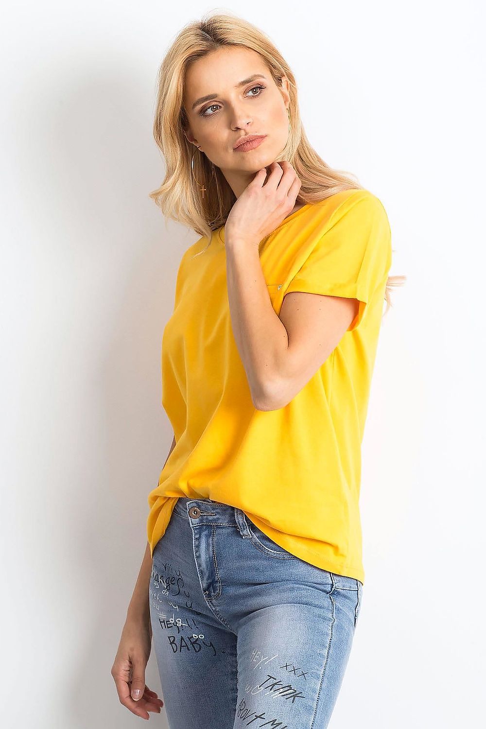 Luxurious Ladies Cotton Spandex Short-Sleeved T-Shirt with Round Neckline, presenting a model taking a pose in a sunny yellow tee, demonstrating its chic and versatile appeal.