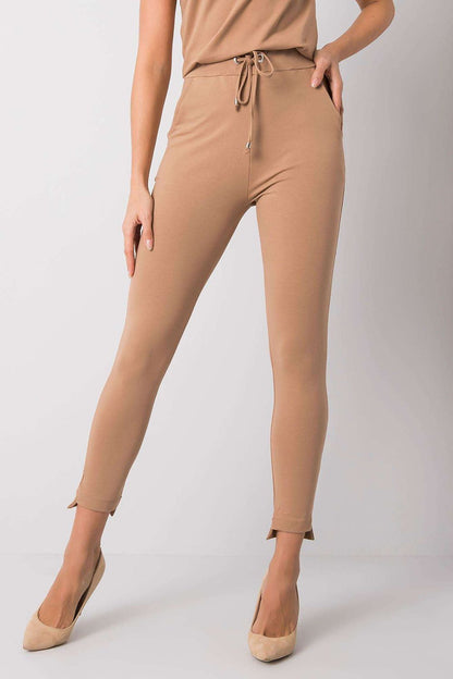 Sophisticated model wearing BFG Luxury Tapered Sweatpants with Adjustable Waist and Side Pockets in a chic beige shade, ideal for luxury loungewear.