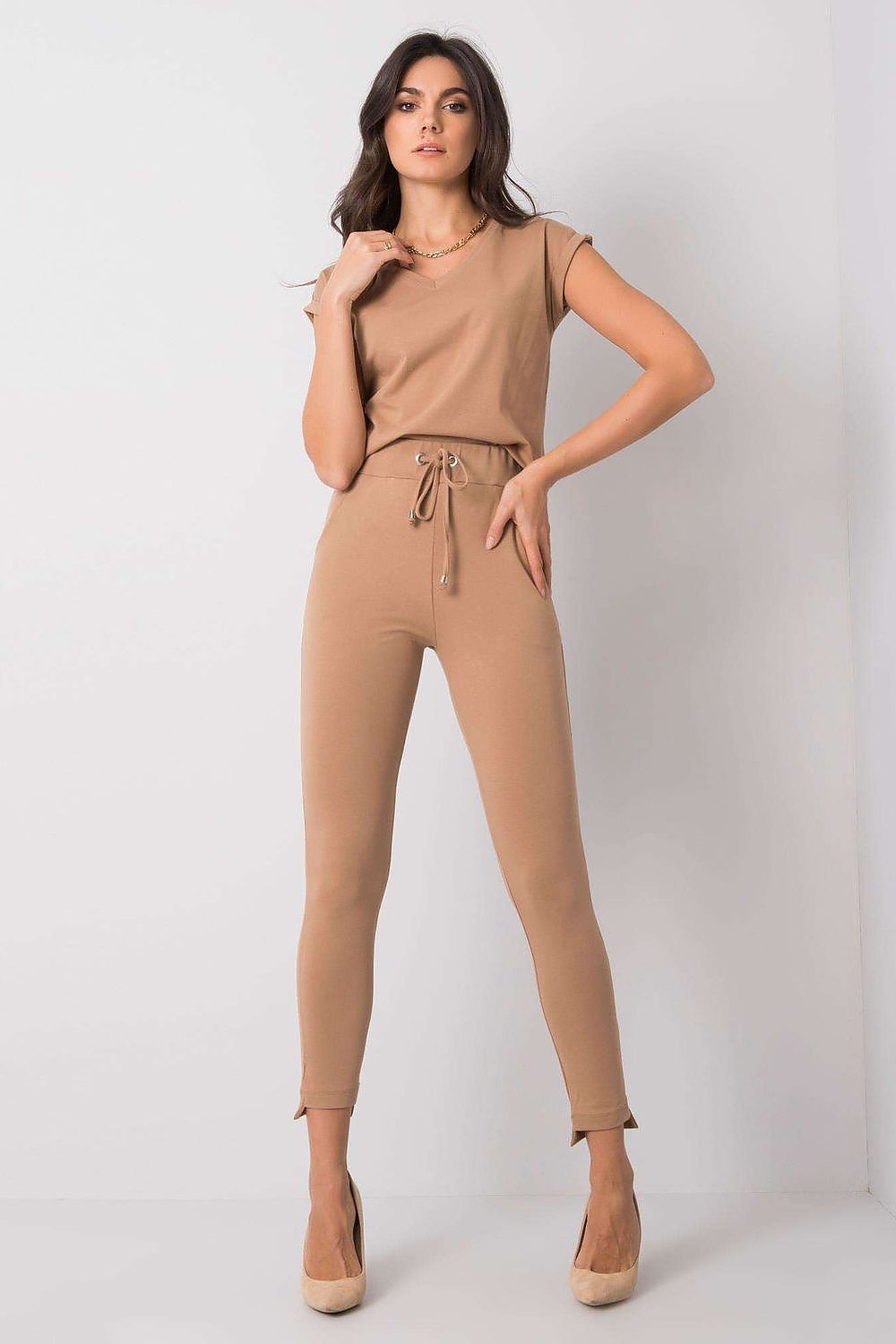 Model striking a pose in BFG Luxury Tapered Sweatpants with Adjustable Waist and Side Pockets, paired with a beige top, showing versatility and style.