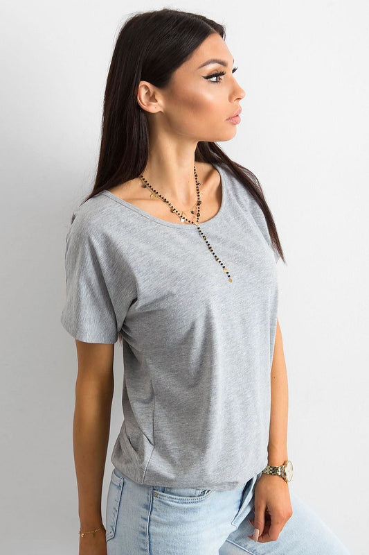 Elegant Ladies' T-Shirt by BFG side view worn by a model, highlighting the short sleeves and round neckline, accessorised with a sophisticated necklace for an elevated appearance.