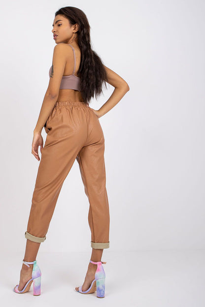 Luxury Women's 7/8 Eco Leather Trousers with High Rise and Decorative Chain by Italy Moda, viewed from the back with stylish pink heels, highlighting the elegant silhouette.