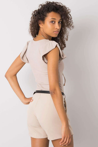 Luxurious Ribbed Frill Blouse with Decorative Cheese Neckline by Italy Moda, showing the model's stylish side view in a beige ribbed blouse with decorative elements.
