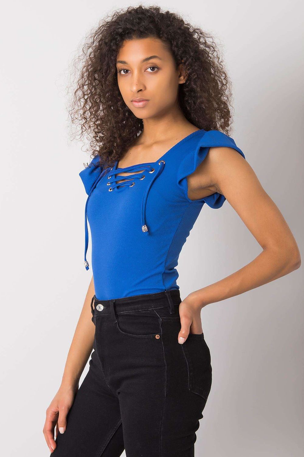 Luxurious Ribbed Frill Blouse with Decorative Cheese Neckline by Italy Moda, showcased on a model from the side, highlighting the ribbed fabric and intricate lacing, paired elegantly with black jeans.