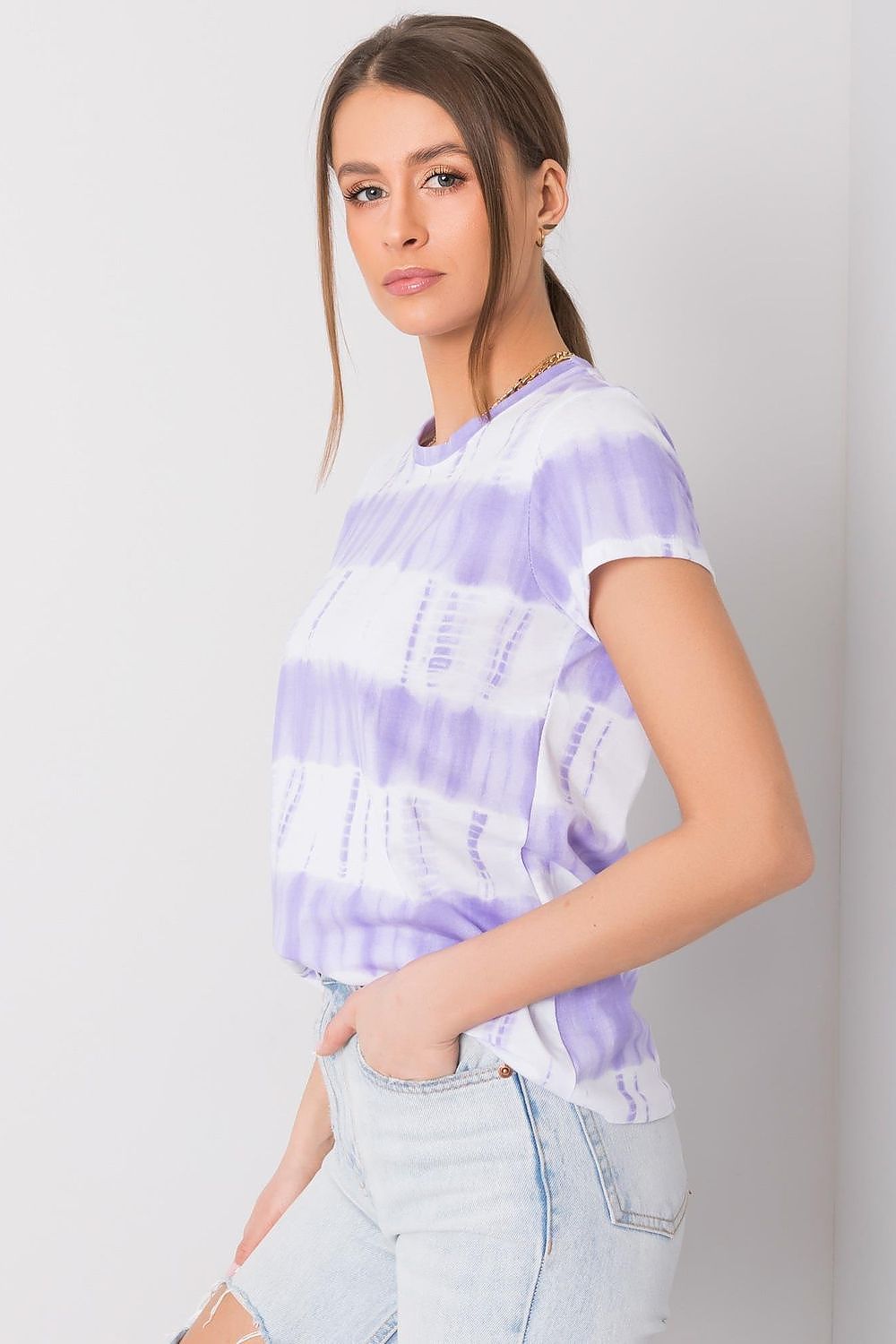 Sophisticated Luxury Women's Cotton Printed T-Shirt with Short Sleeves and Round Neckline by Italy Moda, displaying a beautiful lavender tie-dye effect, paired with trendy high-waisted jeans.