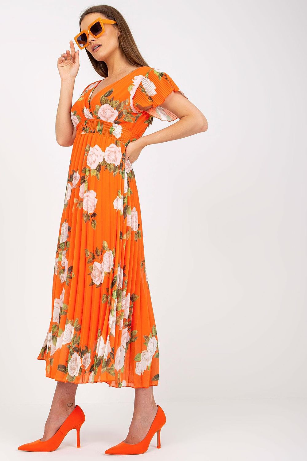 Side view of the Elegant Summer Dress with Frill Sleeves, Envelope Neckline & Pleated Hem by Italy Moda, highlighting a model wearing a beautiful orange dress adorned with soft floral patterns.