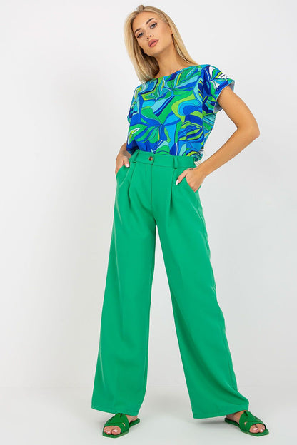 Luxury Women’s Italy Moda Trousers - High Rise Fabric Pants with Zip and Button Fastening, model presenting elegant green trousers paired with a stylish blue and green patterned top.