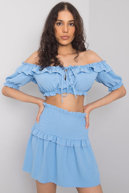 Och Bella Spanish Style Blouse with Tie Front and Short Sleeves - Elegant Polyester Top presented by a model in blue, illustrating a vibrant colour variant with charming ruffle accents.