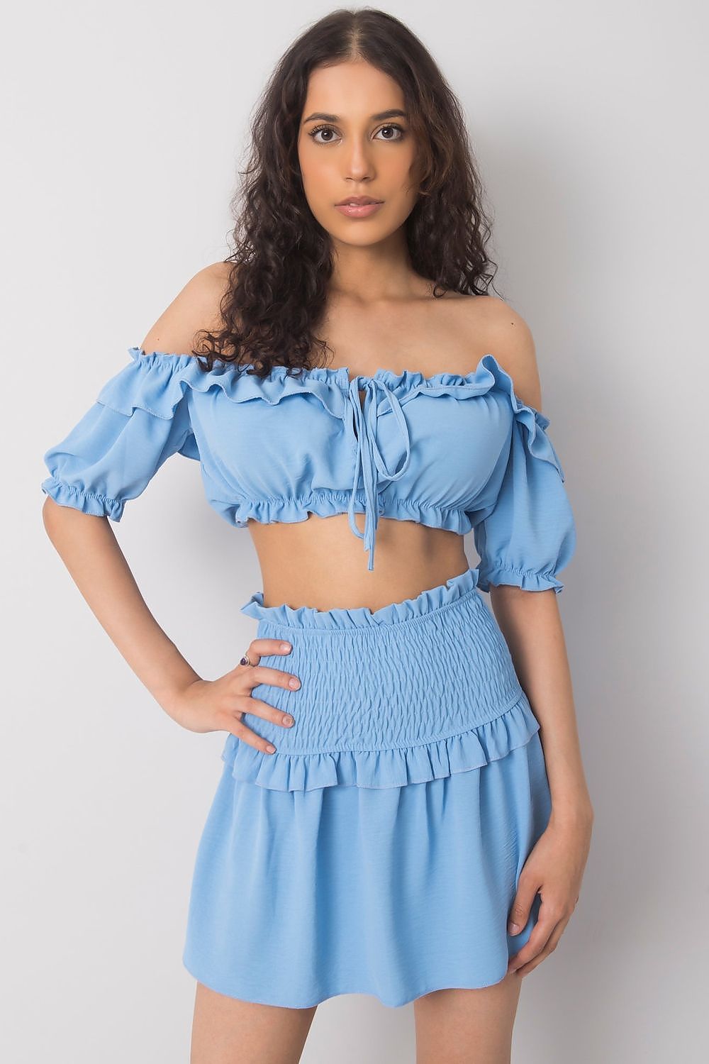 Och Bella Spanish Style Blouse with Tie Front and Short Sleeves - Elegant Polyester Top showcased by a model in a light blue ensemble, featuring ruffle details and a flattering cropped design.