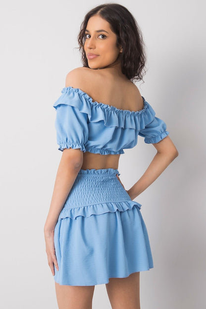 Och Bella Women's Short Summer Skirt with Wide Elastic Waistband in blue, styled with a matching cropped top, perfect for a chic summer look.