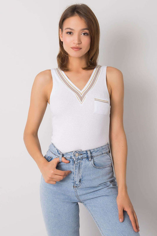 Elegant Och Bella sleeveless t-shirt with a heart neckline and decorative pocket, styled with light denim jeans, embodying luxury and comfort.