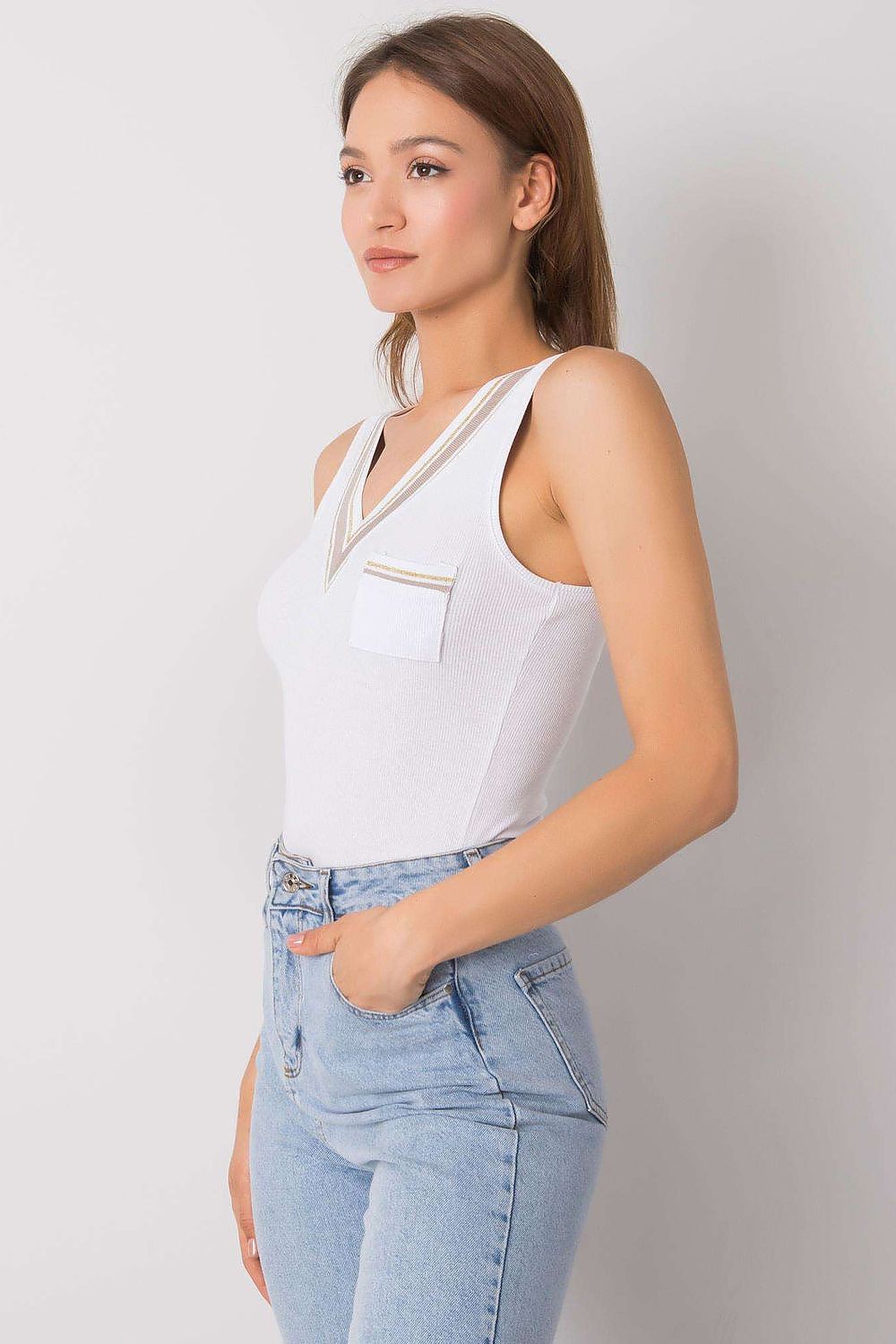 Sophisticated side view of the Och Bella sleeveless t-shirt featuring a heart neckline and decorative pocket, paired expertly with high-waisted denim, perfect for a chic ensemble.