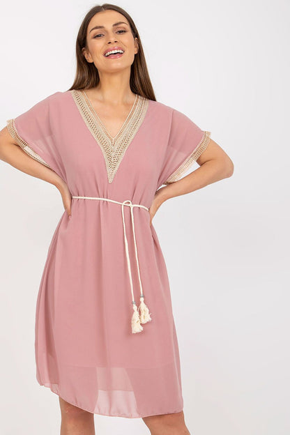 Italy Moda Loose-Fitting Daydress with Heart Neckline and Openwork Inserts, displaying a model in a chic blush pink dress, beautifully tied at the waist for an elegant summer appearance.