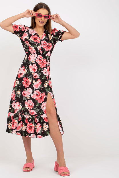 Elegant Floral Summer Dress with Short Sleeves, Front Buttons and Frill by Italy Moda, showcasing a model posing in a vibrant floral pattern dress with a thigh-high slit and stylish pink sunglasses.