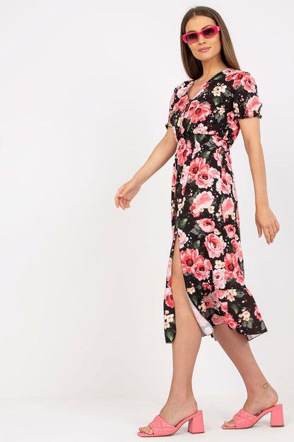 Elegant Floral Summer Dress with Short Sleeves, Front Buttons and Frill by Italy Moda, featuring a model elegantly walking in a floral dress with short sleeves and a slit, paired with chic pink heels.
